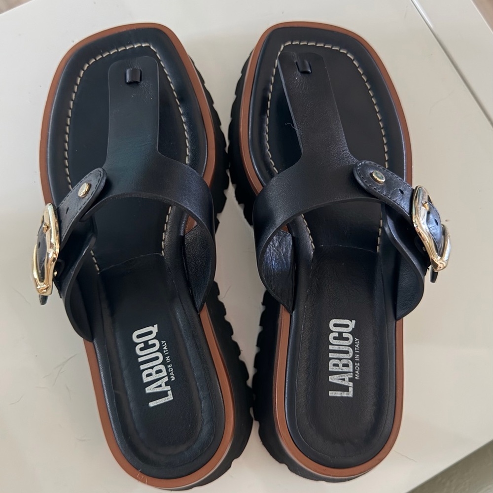 Labucq Black Leather Toe-Post Sandals with Brown Trim and Gold Buckles